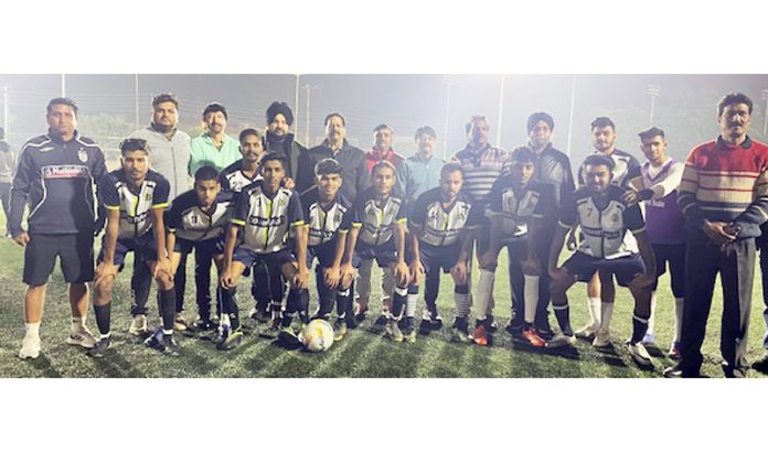 Football players posing with dignitaries during a tournament at Jammu.