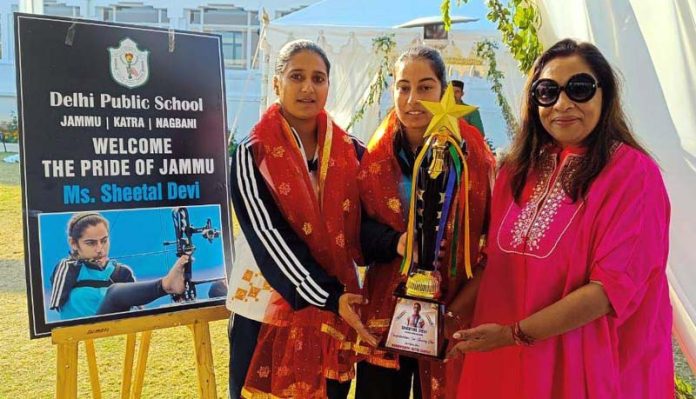 Ritu Singh, founder trustee of DPS Jammu, Katra and Nagbani presenting trophy to archer Sheetal Devi and her coach Abhilasha on Saturday.
