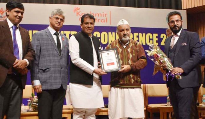 Ravinder Pandita of Save Sharda Committee being presented an award of honour at New Delhi on Tuesday.