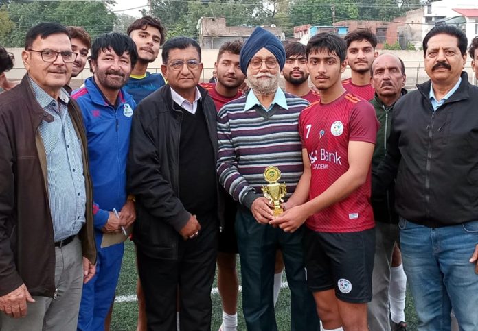 Paras of J&K Bank Academy receiving Man of the Match trophy from a dignitary.