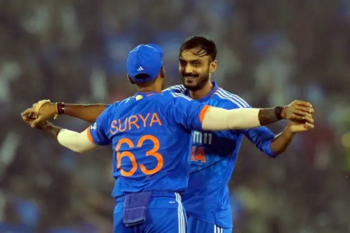 India's Axar Patel celebrates the dismissal of Australia's Ben McDermott with India's captain Suryakumar Yadav.