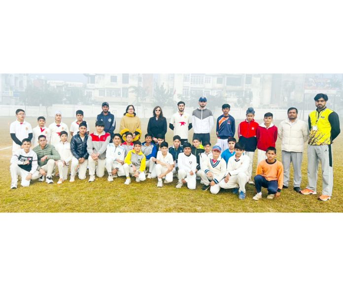 Players posing with teaching staff during inter-school cricket tournament at Jammu on Thursday.