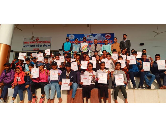 Athletes posing with certificates during the closing ceremony of District Athletic Championship on Thursday.