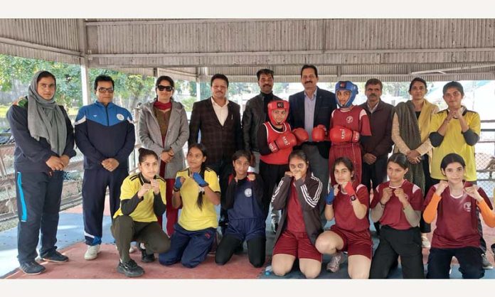 Dr Surinder Sharma, Principal Government SPMR College of Commerce posing with boxing team.
