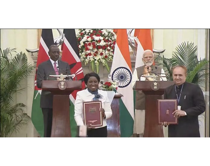 Copies of MoU being displayed in the presence of Kenyan President and the PM Modi.