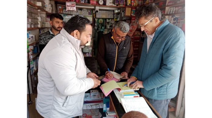 Officers of DFCO Jammu scrutinizing sale records at a chemist shop in Chowki Choura area of Akhnoor.