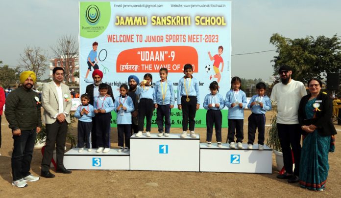 Students of Jammu Sanskriti School posing with medals on podium during junior sports meet on Friday.