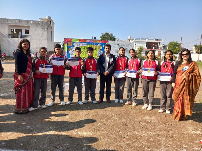 Students displaying certificates during Annual Sports Day.