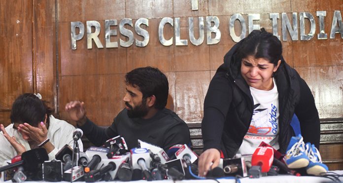 Wrestler's Bajrang Punia, Sakshi Malik and Vinesh Phogat breaks down at a press conference in New Delhi on Thursday.(UNI)