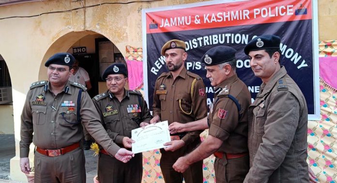IGP Jammu Anand Jain rewarding a police official at Police Station Akhnoor on Tuesday.
