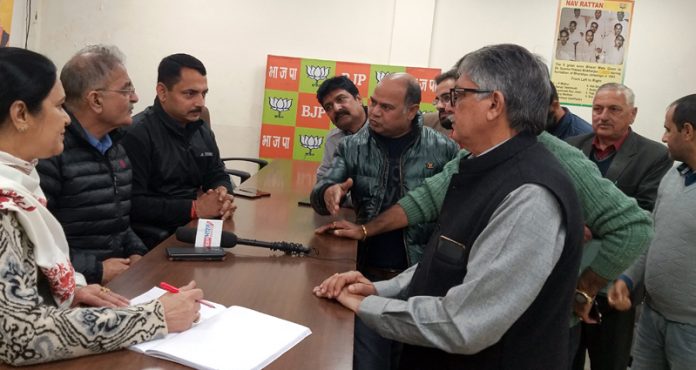 Former Dy CM, Kavinder Gupta and BJP spokesperson, R S Pathania listening public grievances at BJP office Jammu on Tuesday.
