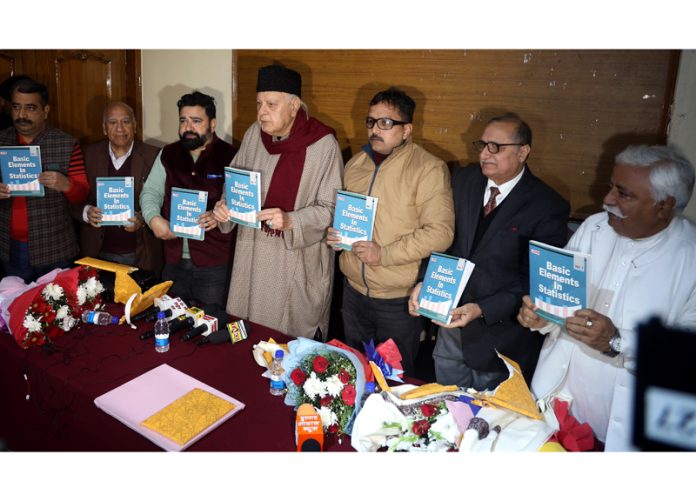 Former CM & MP Dr Farooq Abdullah releasing book of Dr Vikas Sharma during a function at Press Club in Jammu. -Excelsior/Rakesh