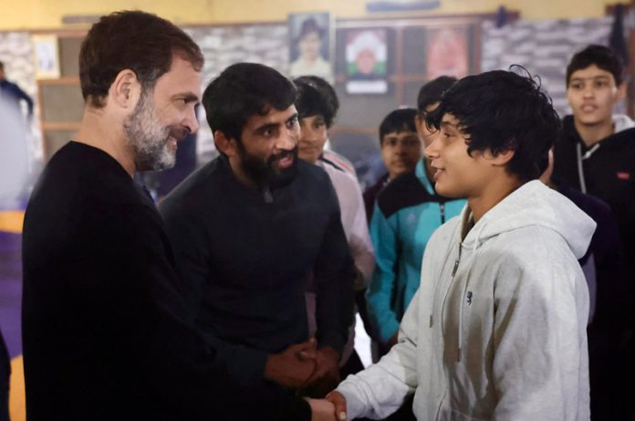Congress leader Rahul Gandhi meets with the wrestlers, including Olympian Bajrang Punia, during his visit to the Virender Arya Akhara, in Jhajjar on Wednesday. (UNI)