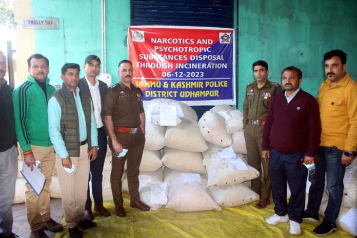 Police and concerned officers displaying the seized narcotics before its incineration.