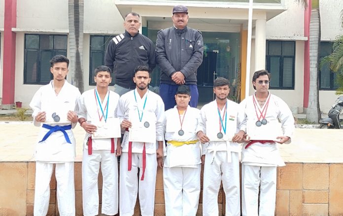 J&K Karatekas posing with instructors during a national competition.