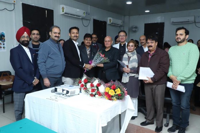 Dr Arvind Kohli presenting a bouquet to Dr Ashutosh Gupta (Principal & Dean, GMC Jammu) during a CME programme at Jammu.