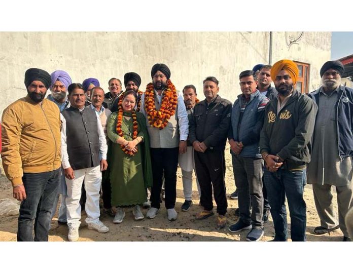 BJP leader, Sarbjit Singh Johal along with others posing for a group photograph after inaugurating road blacktopping work in Ramgarh area of Samba district.