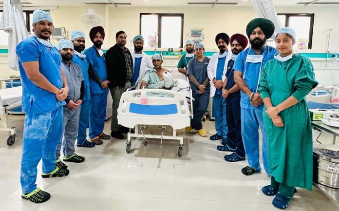 A team of doctors posing with a patient whose hand they successfully re-implanted at Ivy Hospital, Hoshiarpur in Punjab.
