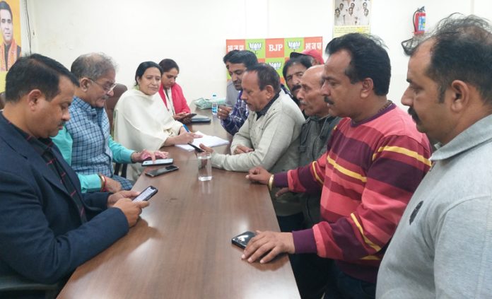 Former Deputy Chief Minister and senior BJP leader Kavinder Gupta listening public grievances in Jammu on Tuesday.