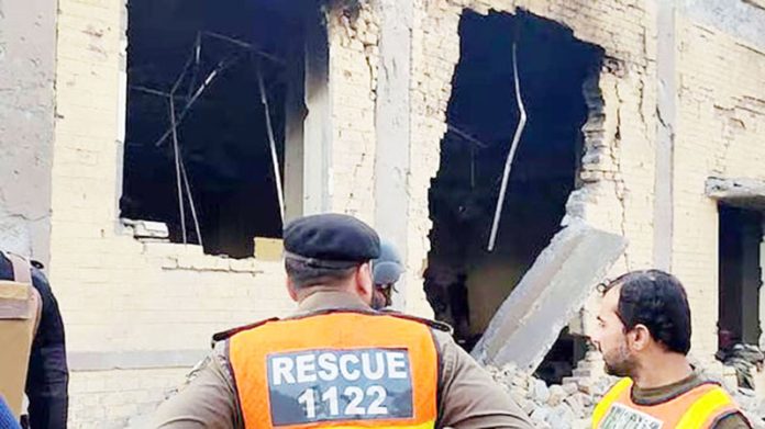 Rescuers examine the site of militant attack in Khyber Pakhtunkhwa.