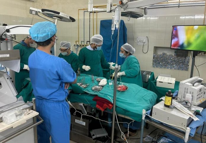 A team of doctors performing cochlear implant surgery on a patient at SMGS Hospital Jammu.