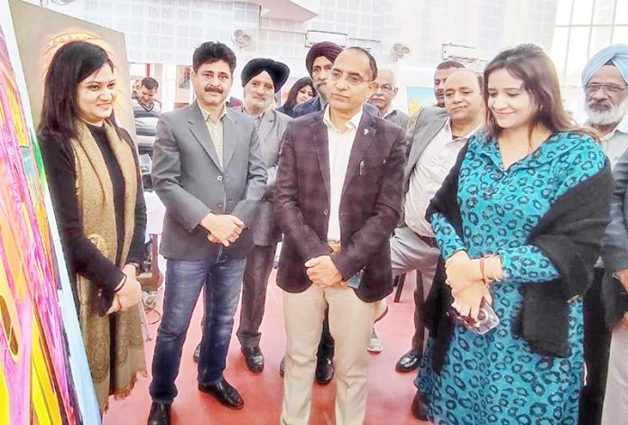 Dignitaries on a round of the exhibition where paintings by budding artists were displayed at Jammu on Thursday.