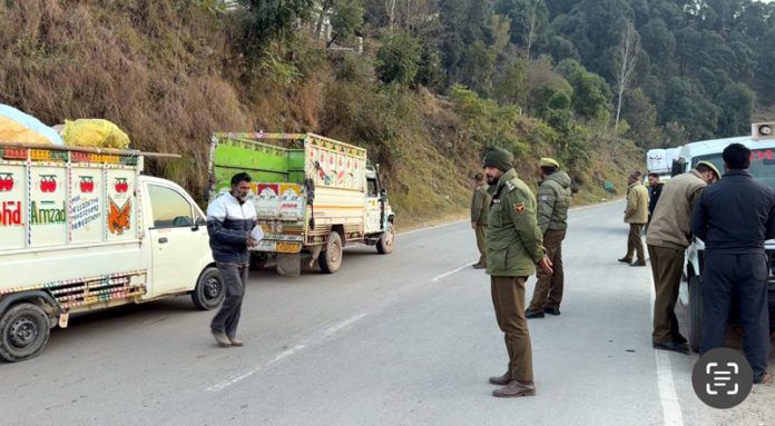 Rajouri Police in action against violators of traffic rules during a naka in Manjakote on Saturday.