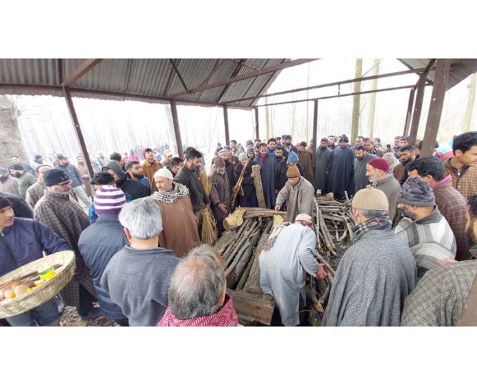 Local Muslims take part in the last rites of a Kashmiri Pandit.