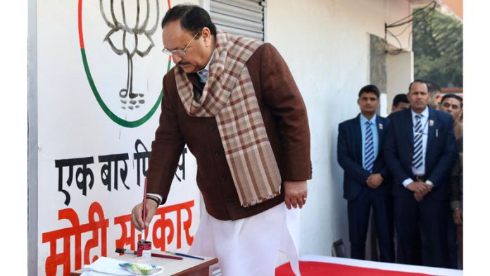 BJP National President J P Nadda painting party's logo on a wall at the launch of party's 'Wall Writing Programme', in New Delhi on Monday. (UNI)