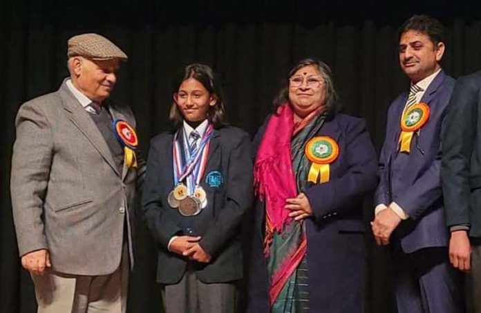 Adhira Kanotra, a National Level Speed Skater being honoured by chief guest during School's Annual cum prize distribution function at Jammu on Tuesday.