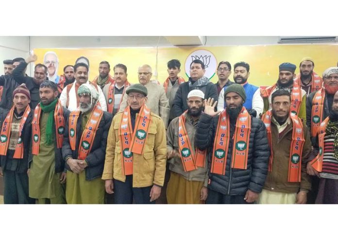 New entrants being taken into party fold by BJP general secretary (Org), Ashok Koul at Jammu on Monday.