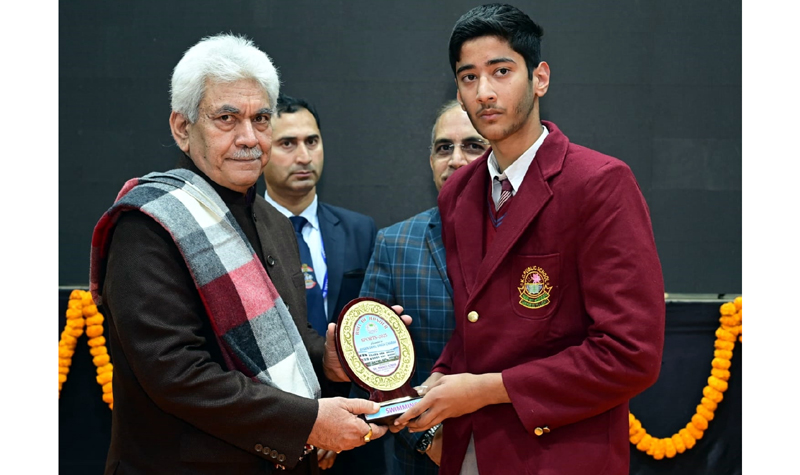 LG Manoj Sinha felicitating a student of KC Public School.