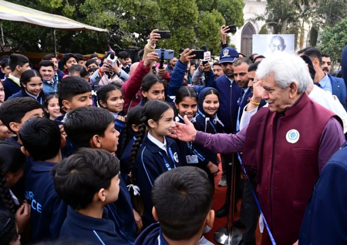 LG Manoj Sinha interacting with students during a function to pay tribute to Mahatma Gandhi in Jammu on Tuesday.