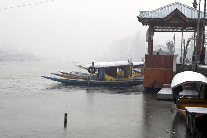 A thin layer of ice formed over Dal lake in Srinagar amid extreme cold conditions. (UNI)