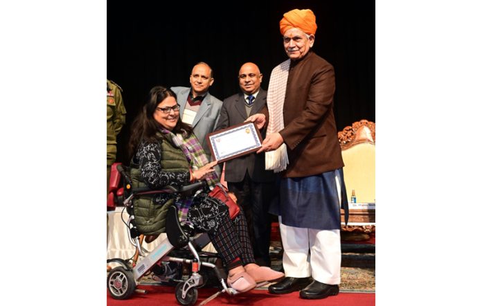 Lt Governor Manoj Sinha presenting award to Sandhya Dhar, founder of Jigar Foundation at Jammu on Wednesday.