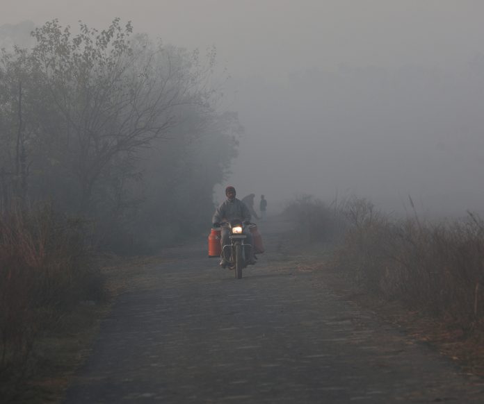 A vendor on his way to sell milk on a foggy morning in Jammu. — Excelsior/Rakesh