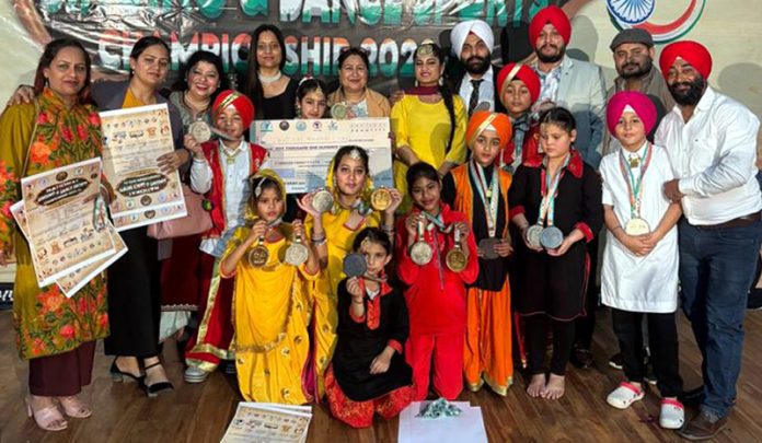 Participants of National Singing & Dance Sports Championship from J&K posing with medals at Madhya Pradesh.