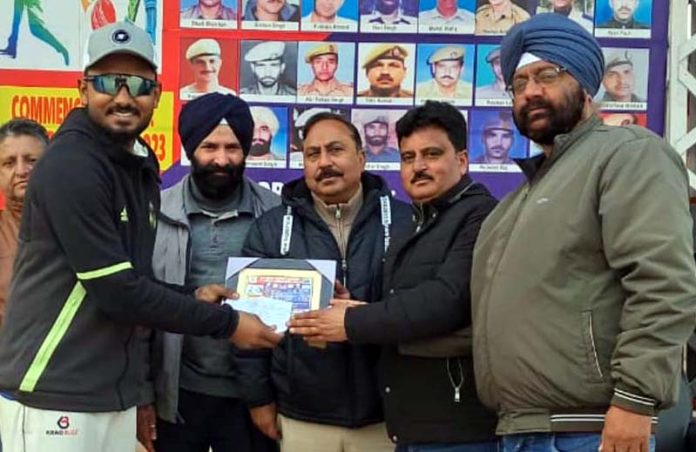 Dignitaries presenting man of the match award to a player in Kathua.