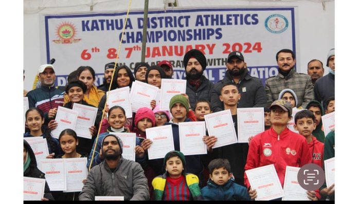 Athletes displaying certificates while posing for group photograph at Kathua.