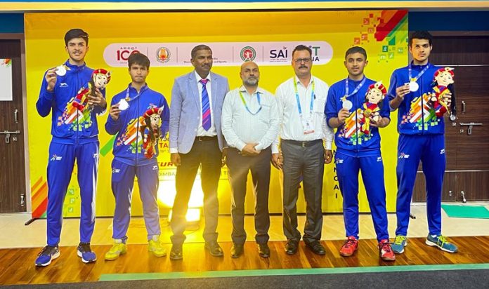 Fencing team displaying medals while posing with officials of Khelo India State Center at Chennai.