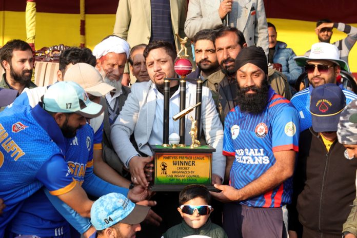 Winning team posing with trophy during Martyrs Premier League at Poonch.