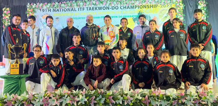 J&K Taekwondo players posing with dignitaries during 19th National ITF Taekwondo Championship at Odisha. 