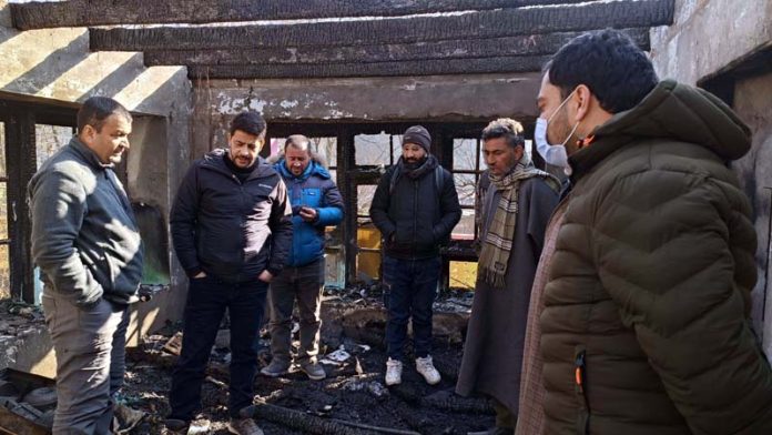 Members of Ganderbal Press Association reviewing the loss of house of Senior Journalist Sheikh Anees on Thursday.