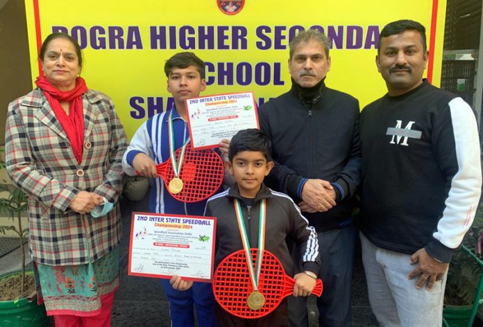 Two students of Dogra Higher Secondary School Shastri Nagar posing with dignitaries.