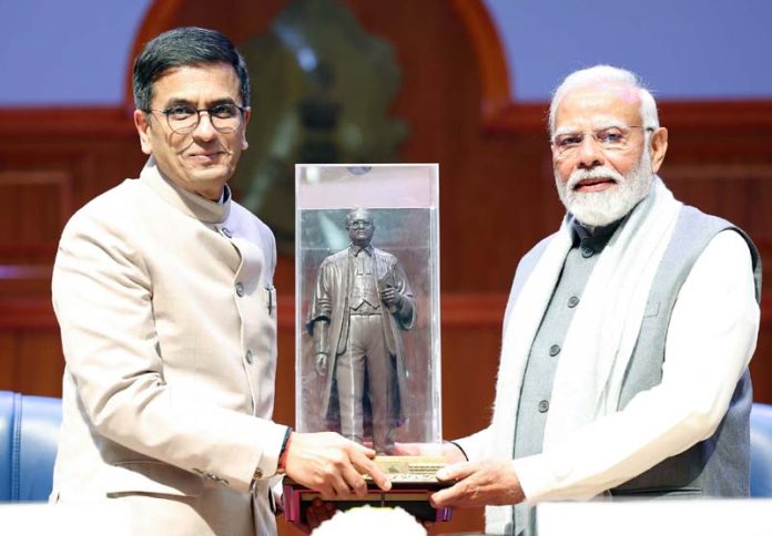 PM Narendra Modi and CJI Dy Chandrachud at a function in New Delhi on Sunday.