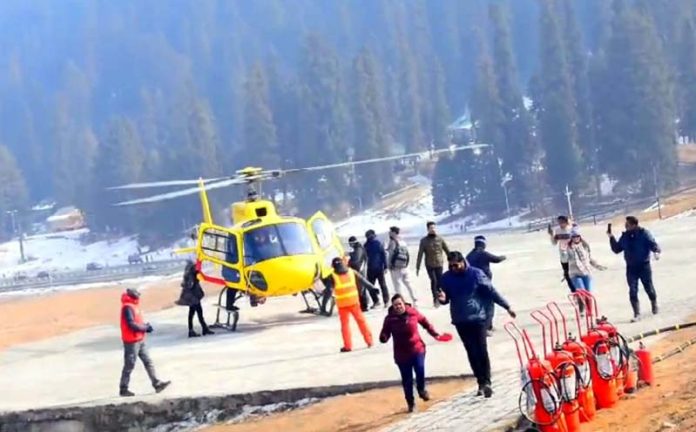 Tourists boarding a helicopter in Gulmarg on Tuesday. -Excelsior/Aabid Nabi