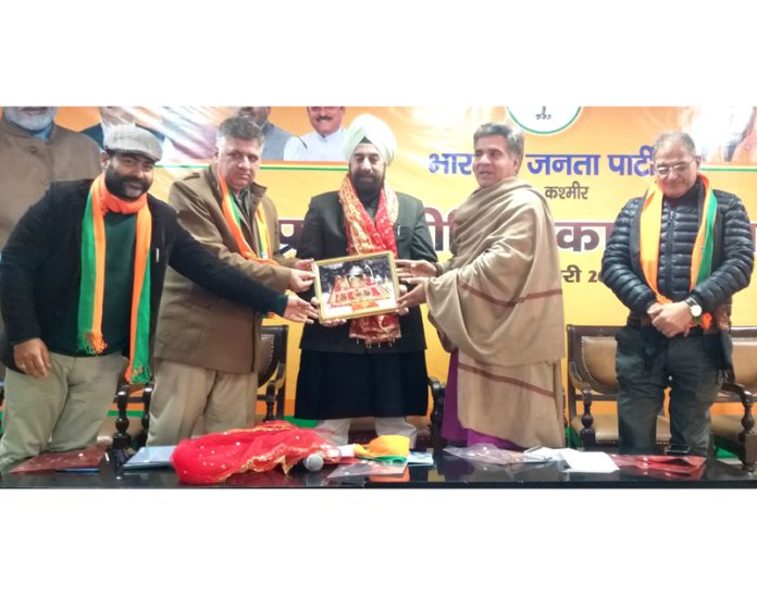 BJP leaders presenting a portrait of Mata Vaishno Devi to party national spokesperson R P Singh at Jammu on Wednesday