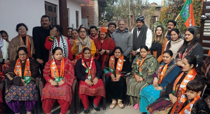 Senior BJP leader and former Deputy Chief Minister, Kavinder Gupta posing with newly joined women party workers at Beli Charana.