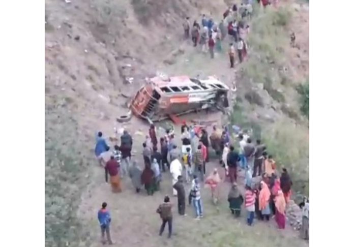 Villagers rescue passengers as bus falls into gorge in Manjakote area of Rajouri on Saturday. -Excelsior/Imran