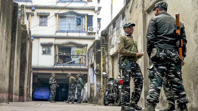 CRPF personnel stand guard during a raid by the Enforcement Directorate (ED) on the residence of TMC MLA Tapas Roy in connection with its probe into the alleged irregularities in recruitments in civic bodies, in Kolkata.